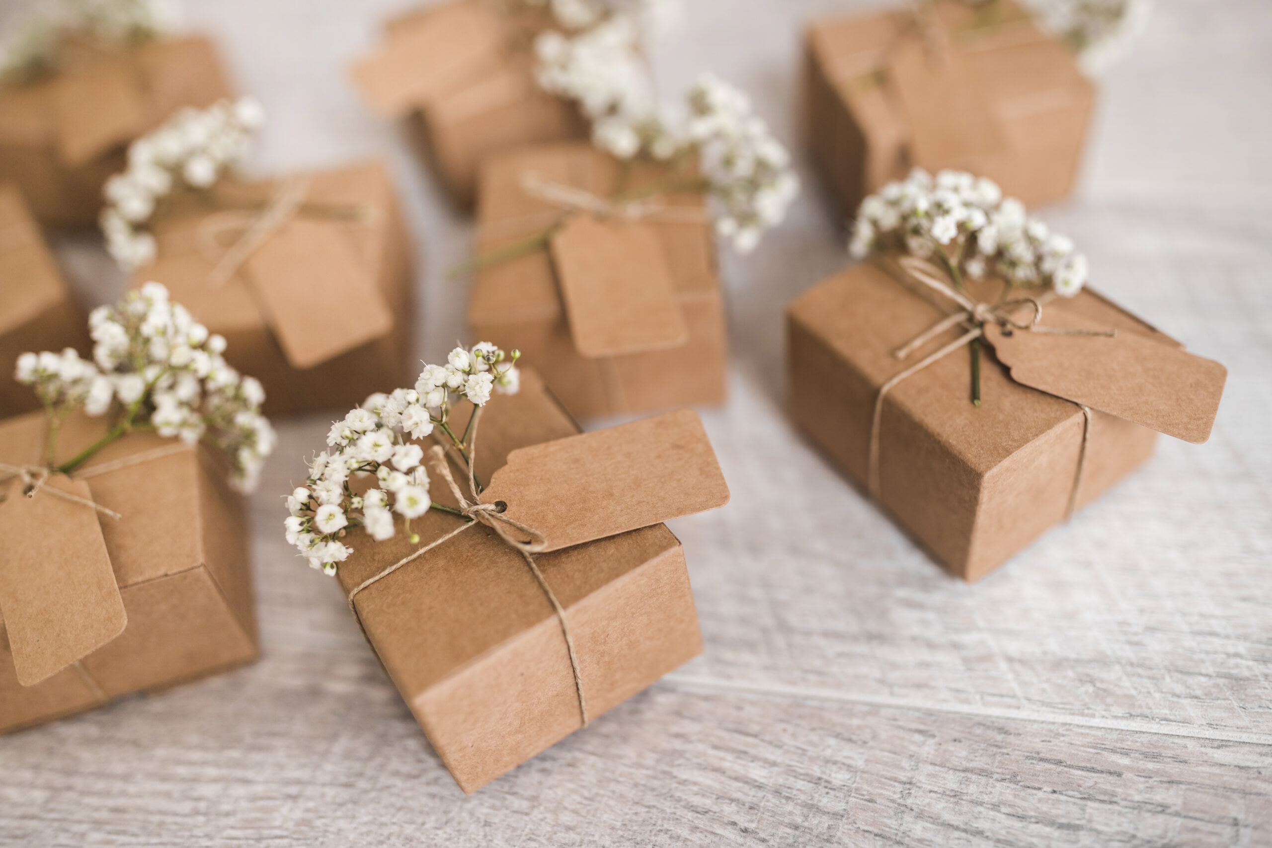 cardboard-gift-boxes-with-tag-baby-s-breath-flowers-wooden-desk