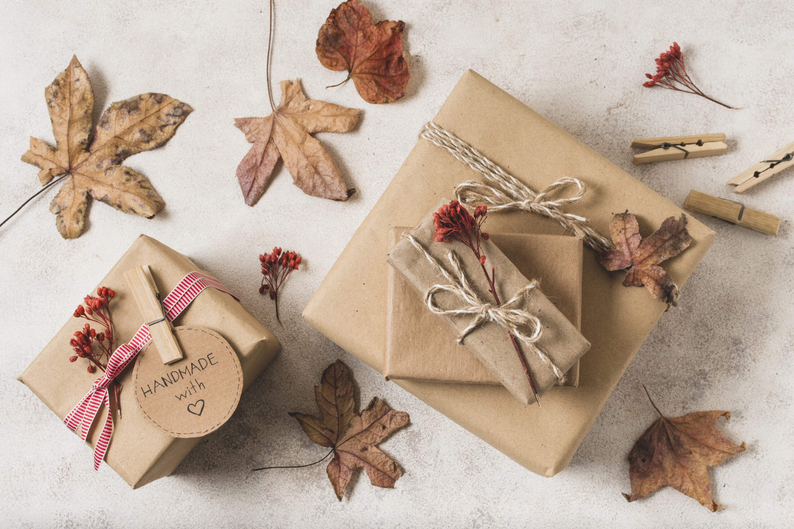 flat-lay-gift-boxes-with-dead-leaves-clothing-pins