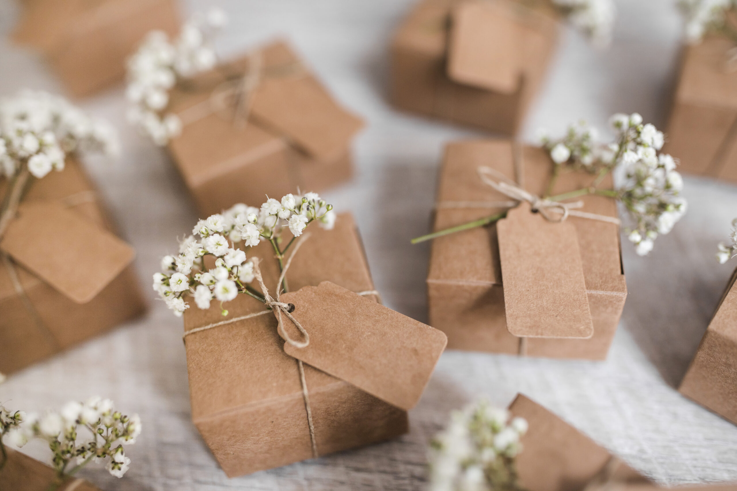 full-frame-cardboard-boxes-with-tag-baby-s-breath-flowers-wooden-backdrop