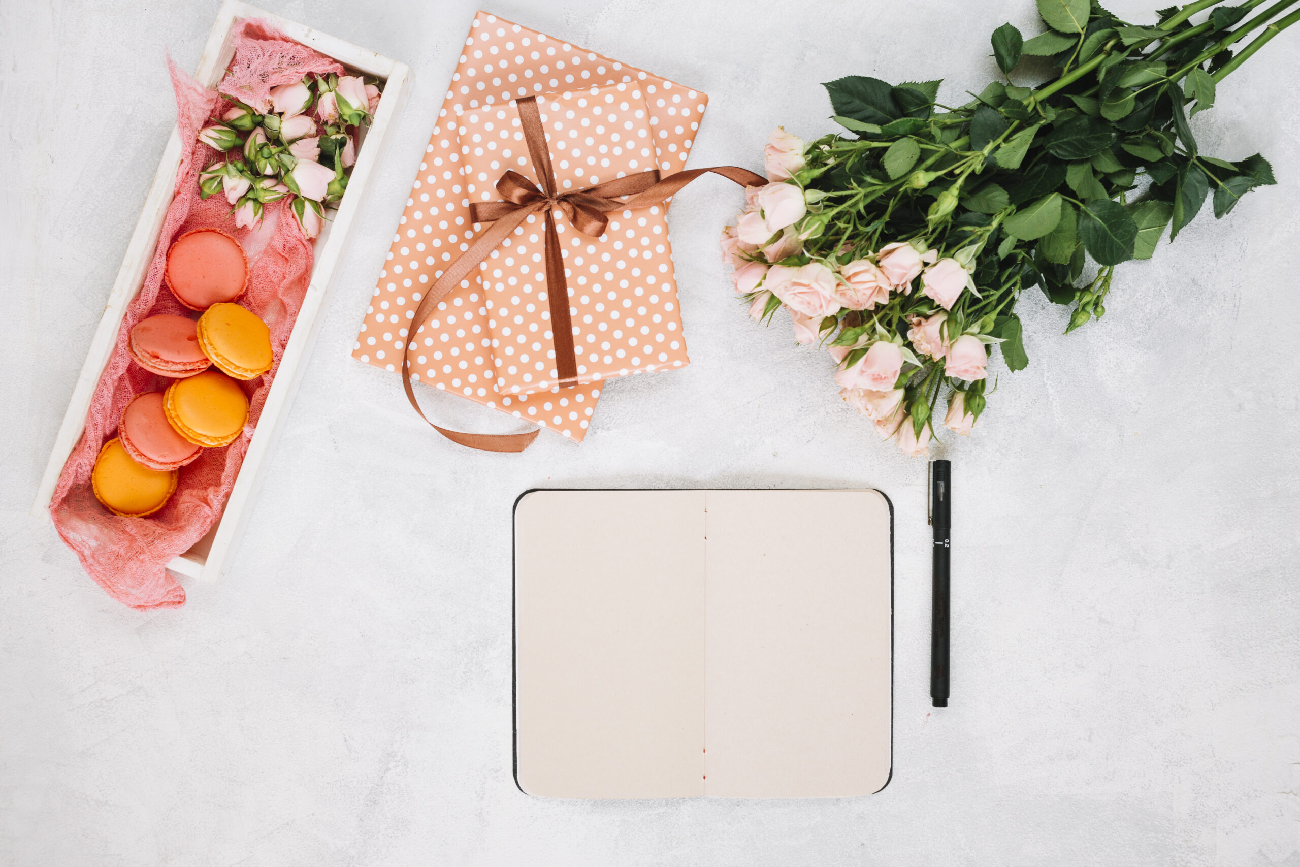 roses-near-notebook-presents