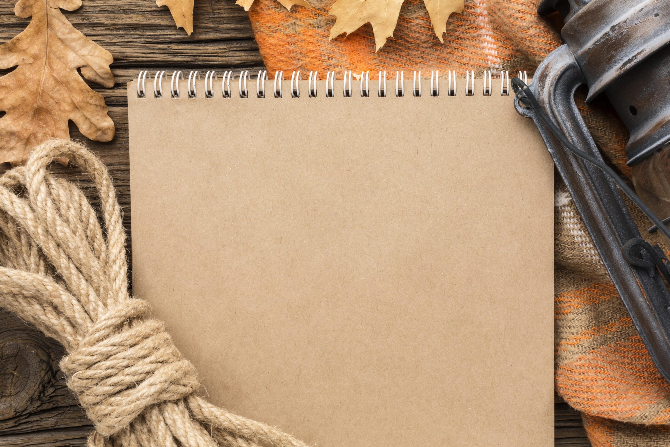 top-view-notebook-with-autumn-leaves
